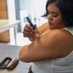 a person with an insulin injection pen