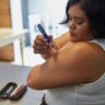 a person with an insulin injection pen